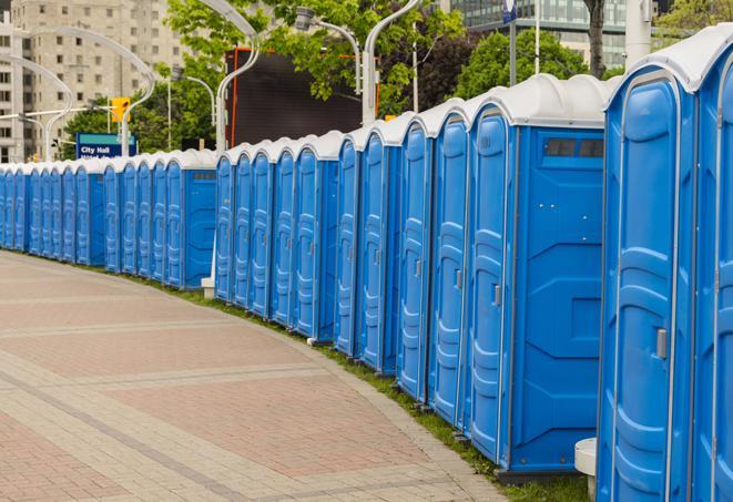 a row of portable restrooms set up for a large athletic event, allowing participants and spectators to easily take care of their needs in Alden, NY